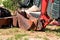 Part of excavator, bulldozer machine and worker tractor, closeup. Renovation on way. Road machinery at construction site.