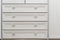 Part of facade of wooden dresser, modern design chest of drawers, commode with four boxes, home storage system