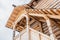 Part of the facade of a wooden house in ancient style. Beautiful wooden veranda on the second floor view from below and sun rays