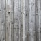 Part of fence with grey weathered planks