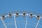 Part of Ferris wheel with blue sky