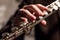 Part of a flute with the right hand of a man on a flute close-up. Shallow depth of field. Musical theme. Wind instrument. Modeling