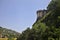 Part of a fortification on a cliff seen from a park below