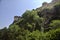 Part of a fortification on a cliff seen from a park below