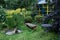 Part of Garden with handmade wooden greenhouse, bench, table and plentiful greens of different types. Landscaping.