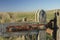 part of a gate overlooking a field out of focus from behind