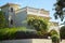 Part of house with terrace wreathed in flowering shrub