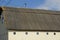 Part of a large rural house with a gray slate roof