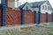 Part of a long private fence of red and black bricks