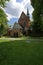 Part of the Luebeck cathedral with narthex and ridge turret, view from the idyllic churchyard with  lawn and old trees, copy space