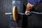 A part of man`s hand, holding gymnastic barbell