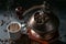 Part of a manual vintage coffee grinder, cup with the hot drink and roasted beans on a dark rustic background, selected focus