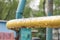 Part of a metal structure from a Playground with drops on it after rain