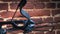 Part of modern compound crossbow handgun on the red brick wall background. Old weapon concept.