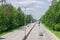 Part of motorway with forest on both sides in summer