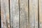 Part of an old fence. dry wooden boards. Old nails left rust on wood. Grunge wooden fence wall background texture