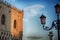 The part of Palace of Doges in Venice, Italy and the street lamp in the evening light.