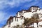 The part of the Potala Palace, with the people republic of China flag inside as well as many windows, curtain, Brick wall, Potala