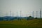 Part of a power line with wind turbines in Bavaria, Germany