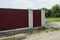 Part of a private wall of a fence made of red metal