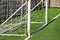 Part of soccer goal door with white net. Close up for football goal at soccer field with green grass and sport stadium, white line