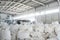 Part of spacious warehouse or storage room with heaps of huge white sacks