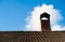 A part of tiling roof with chimney heaven background