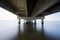 part under the Vasco da Gama bridge in perspective of infinity with the supporting pillars visible.