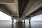 part under the Vasco da Gama bridge in perspective of infinity with the supporting pillars visible.