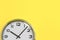 Part of wall clock on yellow background