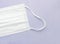 Part of a white surgical mask, 3-layer mask to cover the mouth and nose. The procedure of the mask against bacteria. The