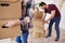 Part of woman carrying cardboard boxes into new apartment