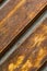 Part of a wooden panel ribbed brown diagonal background rustic windblown close-up texture varnished