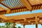 Part of the wooden roof structure on the gazebo on blue sky background