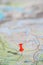 Part of the world topo map as ultimate item for successful travel and red push pin as location marker, abstract, background, paste