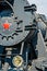 Partial frontal view of a steam locomotive. Gray metal boiler an