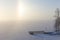 Partial halo and pier at a frozen & snowy lake