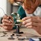 Partial male engineer wearing glasses solder chip