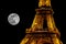 Partial picture of Eiffel Tower and of full moon