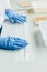 partial view of biologist in latex gloves working at table with seeds in agro