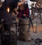 Partial view of a blacksmith shaping the hot metal in his smithy