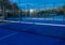 Partial view of a blue paddle tennis court