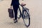 partial view of businesswoman with briefcase and retro bicycle