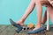 partial view of girl in shoes sitting on chair with mess