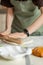 Partial view of kitchen worktop with cooking and hands of chef with electronic clock. Copy space, vertical