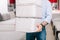 partial view of man holding pile of folding mattresses in hands in furniture store