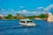 Partial view of old galleon and taxi boat sailing on blue lake at  Epcot in Walt Disney World .