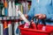 partial view of shopper putting detergent into shopping basket