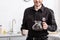 partial view of smiling policeman holding glass pot of filtered coffee