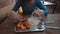 Partial view of a woman eating shrimp and rice on the table.